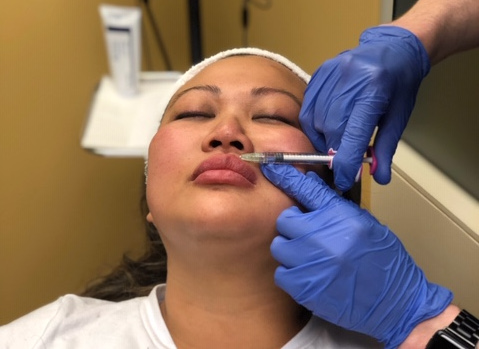 Doctor administering an injectable on a female patient